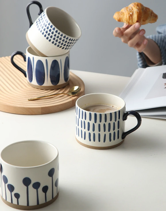 Cup Of Coffee In Blue Seeds Grounded Art Mug With Other Blue And White Pottery Cups Also On Table