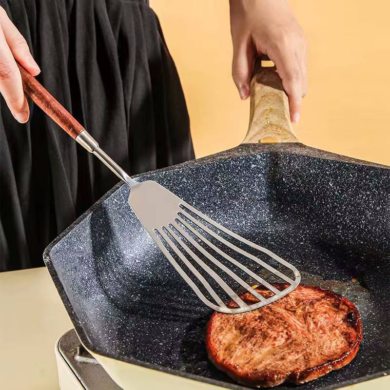 Home Chef Cooking Meat With Sleek Style Slotted Turner Spatula Made Of Stainless Steel Metal And Wooden Handle Of Walnut