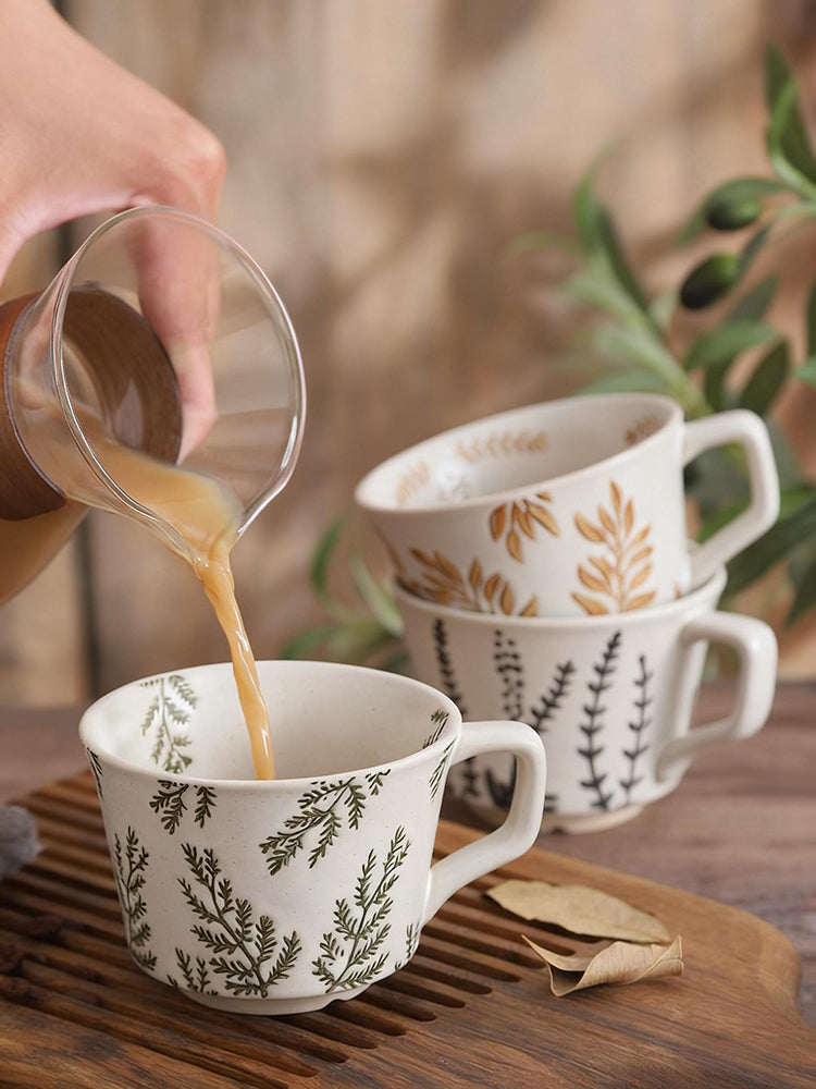 Pouring Hot Tea or Coffee Into Organic Botanics Ceramic Tea Cup In Evergreen Forrest Pattern