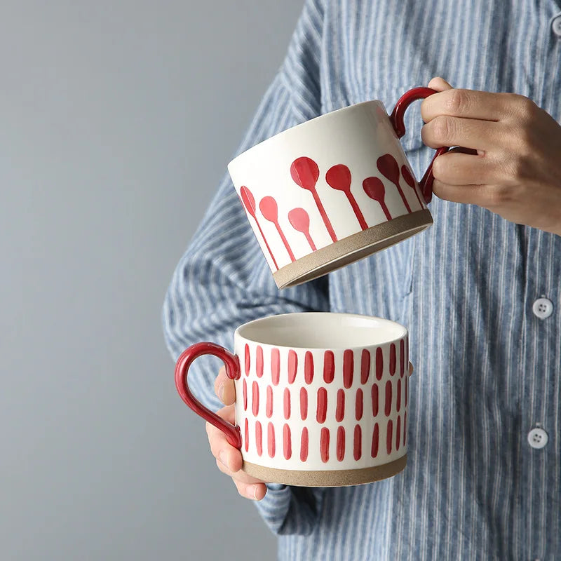 Holding Ceramic Mugs With Red Pattern And Exposed Pottery Base Grounded Art Sprouts And Seeds