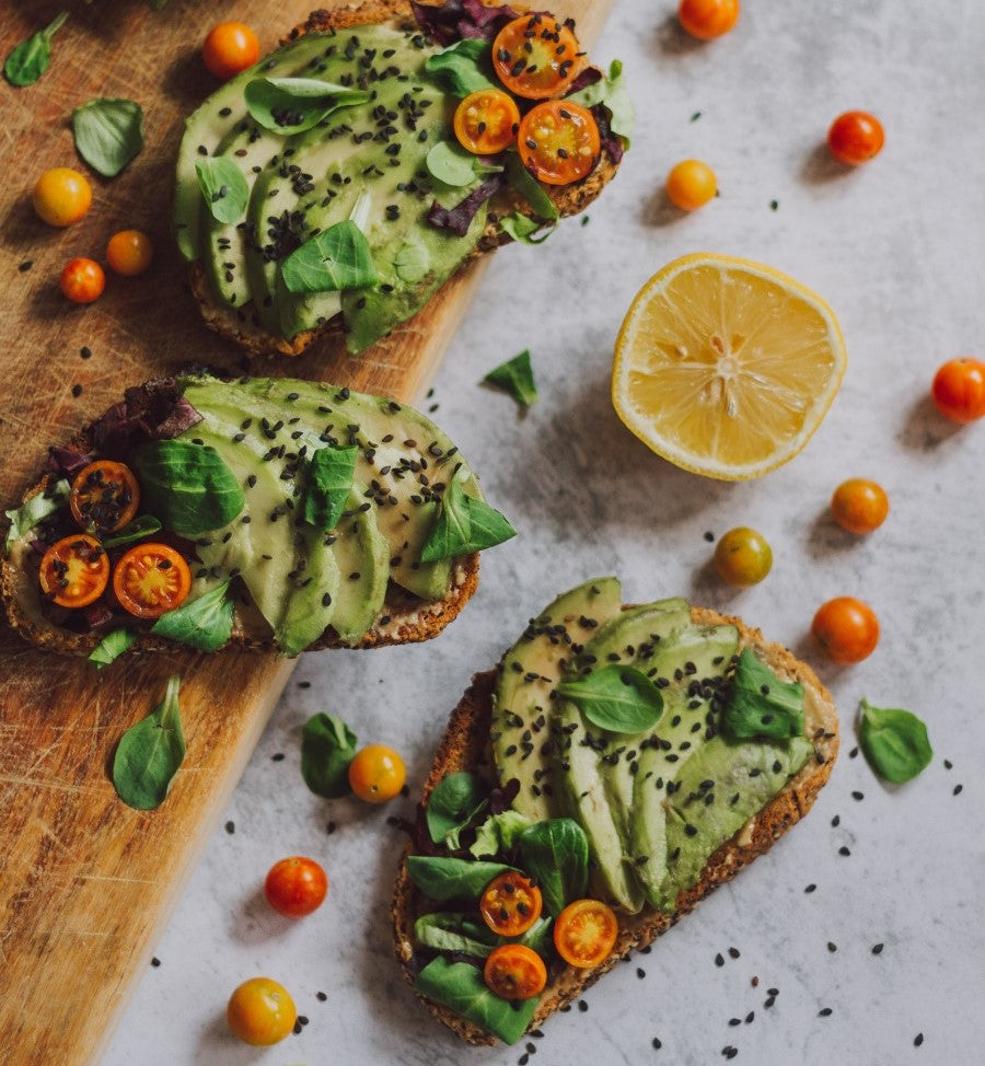 Avocado Herb And Mini Tomato Topped Bread Slices