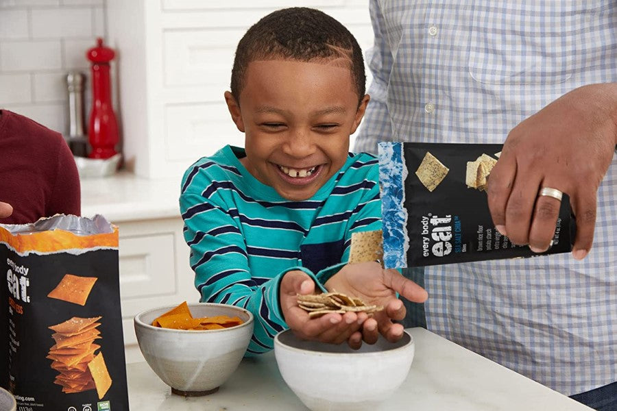 Father Pouring Some Every Body Eat Sea Salt Chia Cracker Thins For Son To Snack