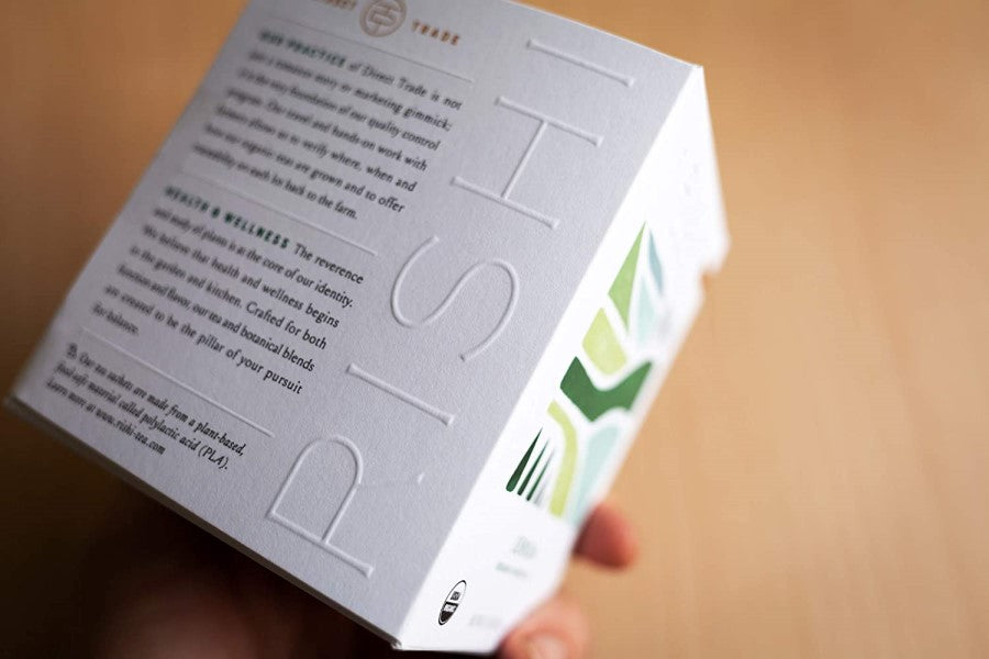 Holding A Stylish Box Of Rishi Sencha Green Tea