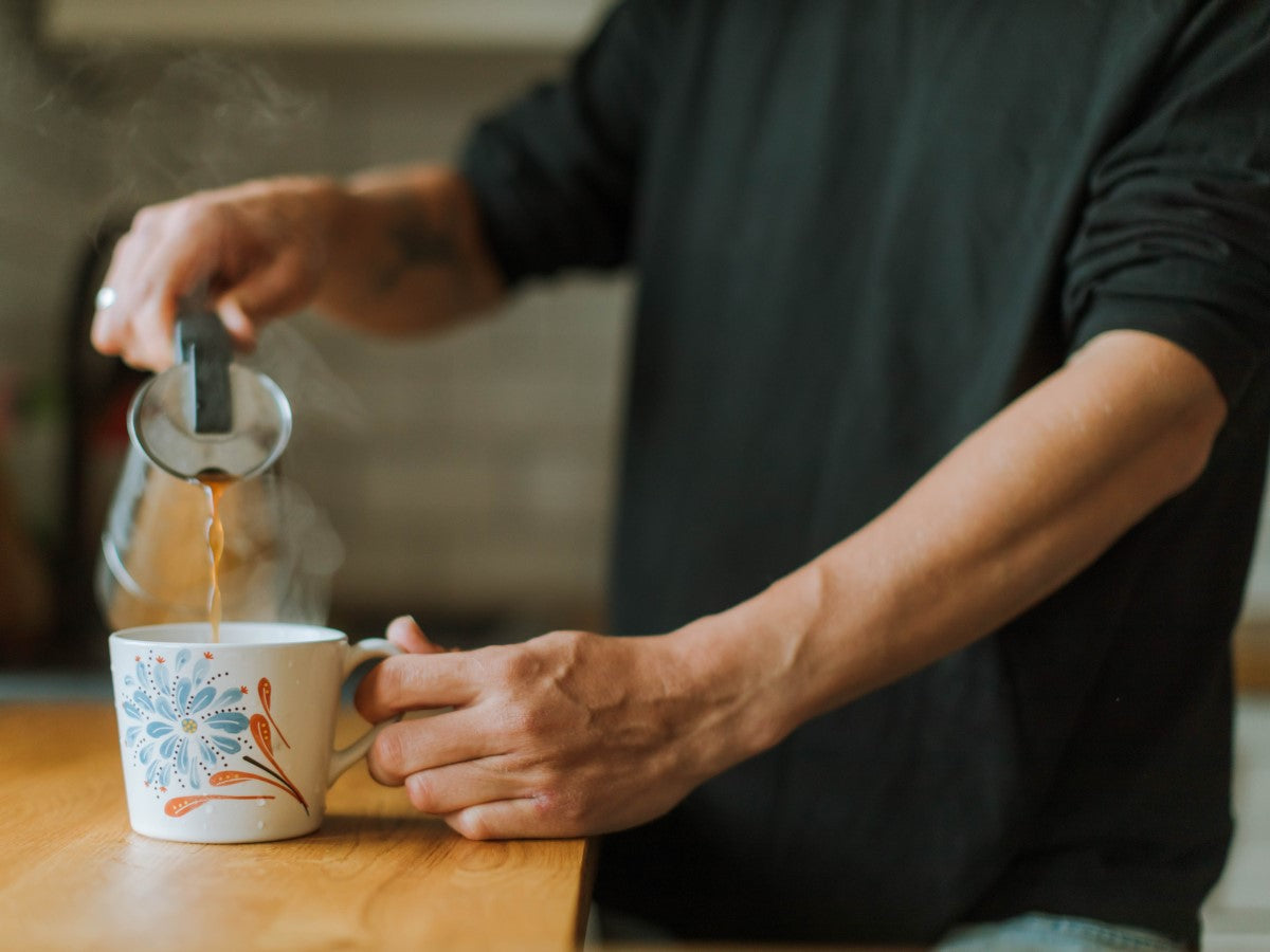 Man Pouring Cup Of Jim's French Roast Organic Coffee