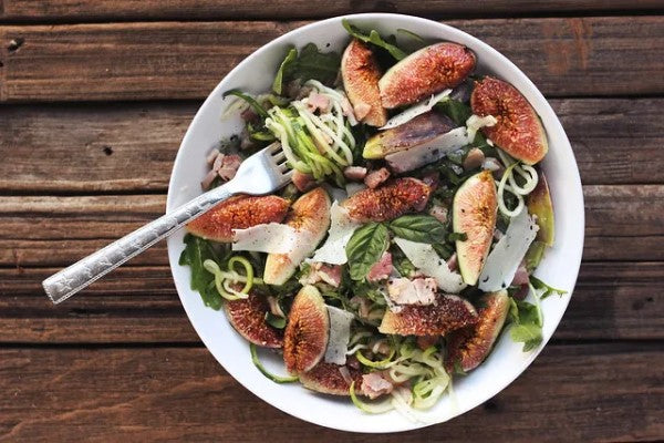 Bowl Of Gluten Free Zucchini Noodles With Fig Arugula And Pancetta Recipe Using Organic Olive Oil From Terra Delyssa